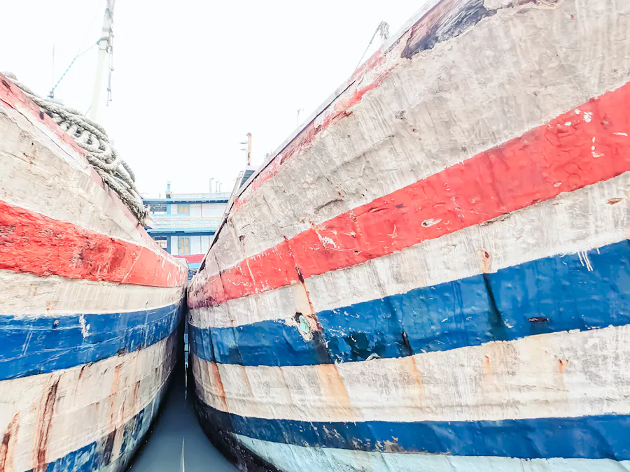 The painted bows of two Indonesian passenger ships at a pier