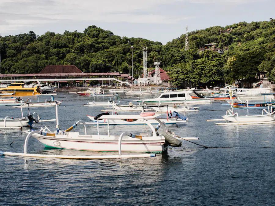 Wooden outrigger boats moored along a busy Indonesian harbour