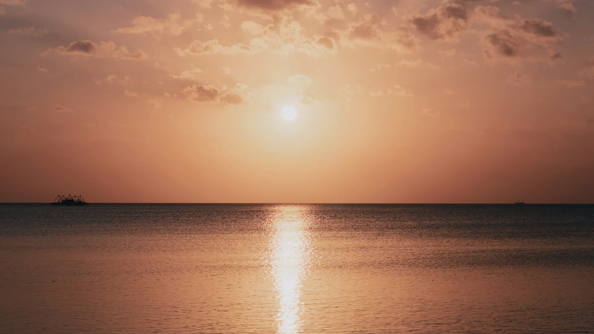 The sun low over a calm sea in Maluku