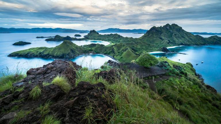 Green volcanic islands scattered across clear blue water