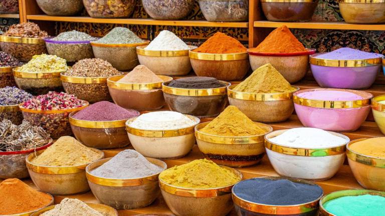 Spices displayed in bowls at a market stall